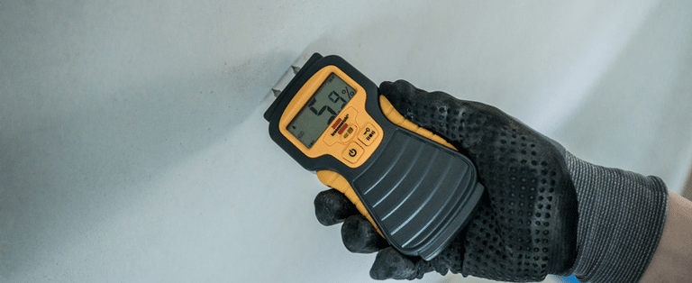 A Comprehensive Guide to Moisture Meters Types, Uses, and Best Practices - Picture of a moisture meter in use.